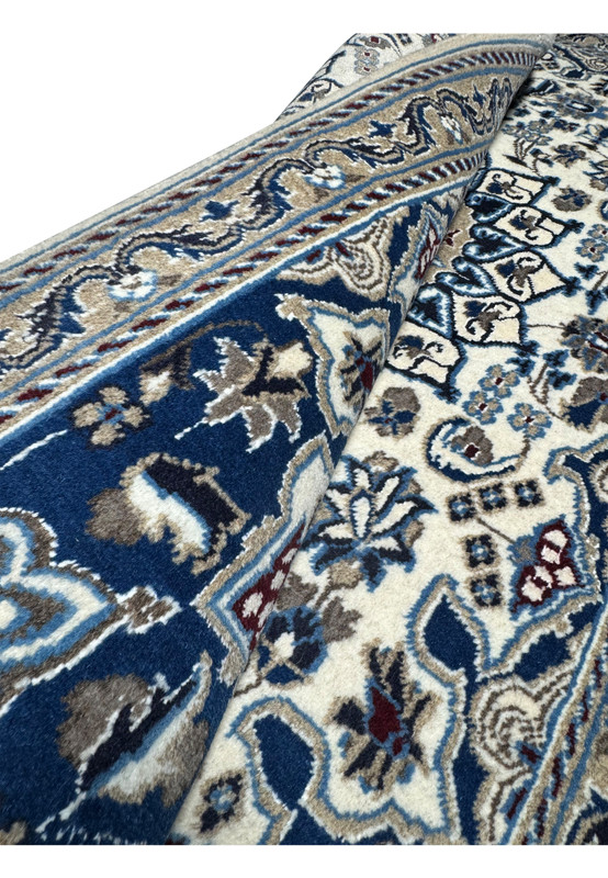 Rolled view showing thickness and flexible structure of hand knotted Persian Nain rug