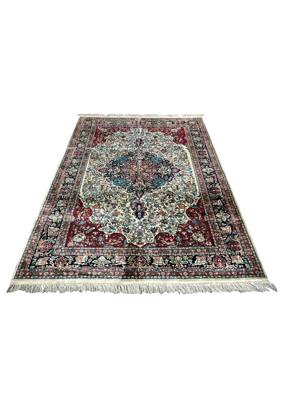 6 x 9 hand knotted silk rug laid flat showing full floral medallion composition