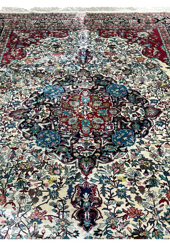 Close-up of floral medallion on fine weave oriental silk rug