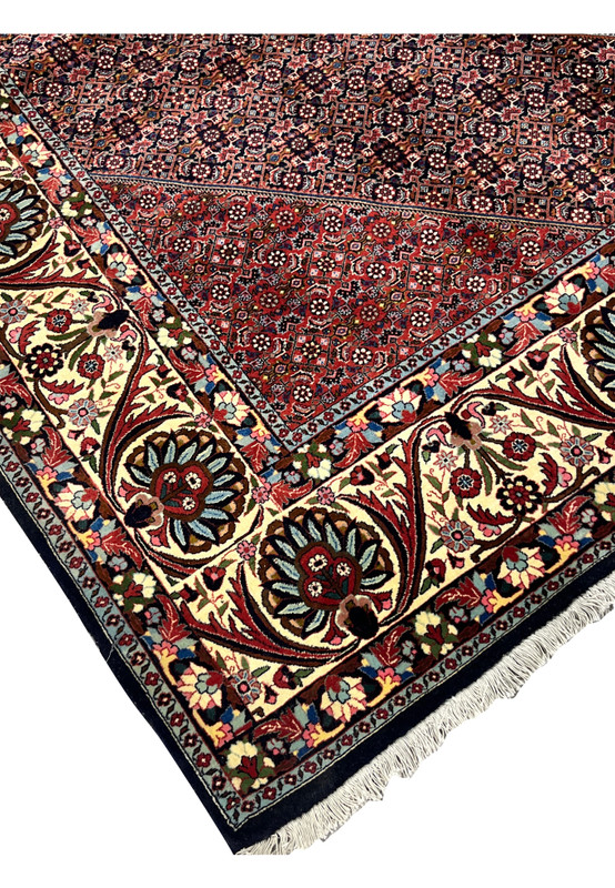 Edge detail showing the firm construction and tightly packed wool pile of a Persian Bijar iron rug