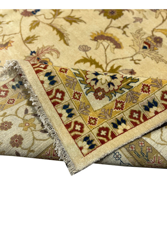 Folded corner showing pile density and border detail of an Indian Jaipur wool rug