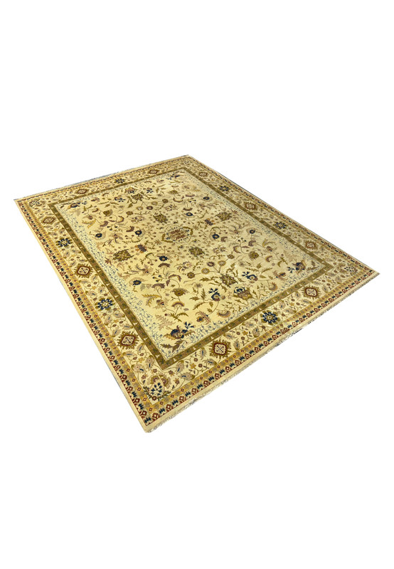 Angled view showing ivory Jaipur rug field with scrolling floral vines and layered borders