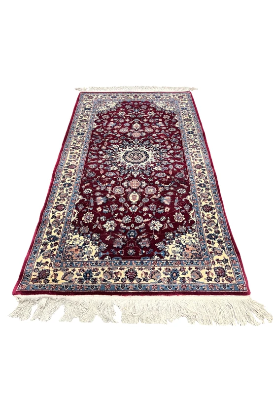 Laid flat view of a 2'4 x 4'7 Persian Tabriz rug highlighting its centered medallion, deep burgundy ground, ivory framing, and detailed floral pattern