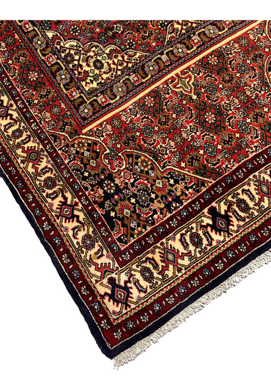 Edge detail of a Persian Bijar rug showing tight knotting, secure borders, dense weave, and the firm structure typical of iron rugs