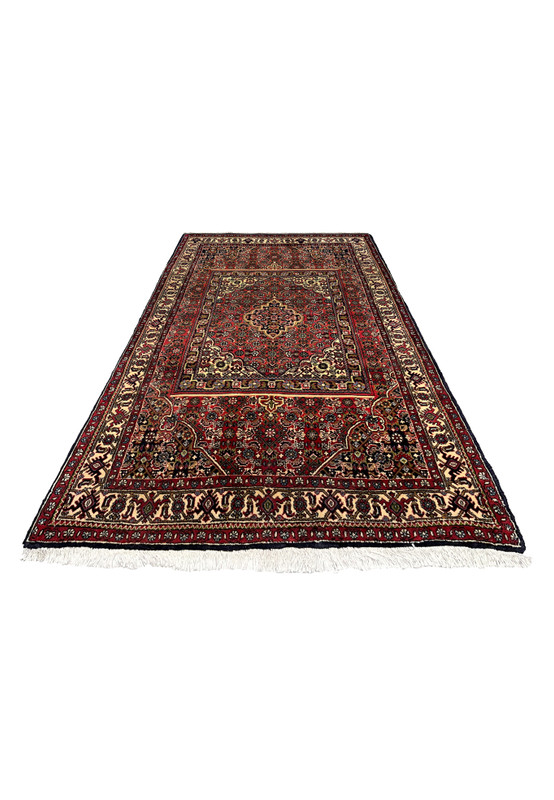 Laid flat view of a Persian Bijar rug showing layered rug-in-rug composition, bold red tones, navy accents, and tightly packed wool texture