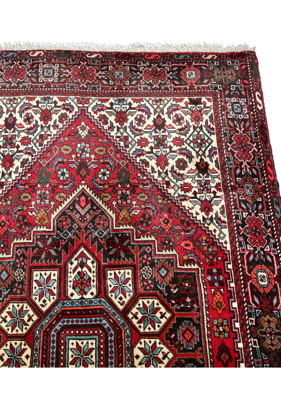 Side view of a Persian Gholtogh rug highlighting thickness, compact wool structure, strong edge binding, and the solid feel of tribal weaving