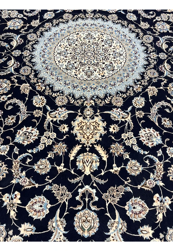 Lower field detail of Persian Nain Habibian silk rug showing scrolling floral motifs, silk sheen, and crisp contrast against navy background