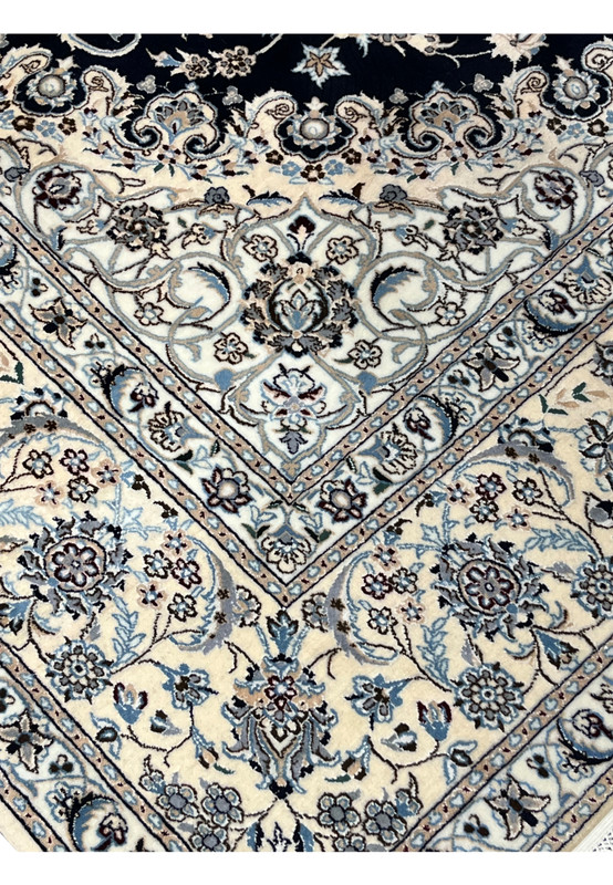 Inner border detail of Persian Nain 6 LA silk rug highlighting fine floral repetition, light blue accents, and sharp silk definition