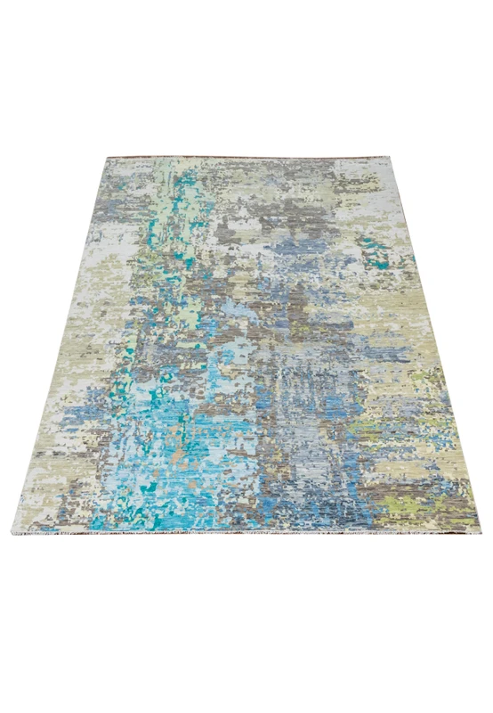 Angled view of a 12 x 14'7 modern handmade Nepali abstract wool rug showing flowing blue and ivory color transitions and an expansive contemporary surface.