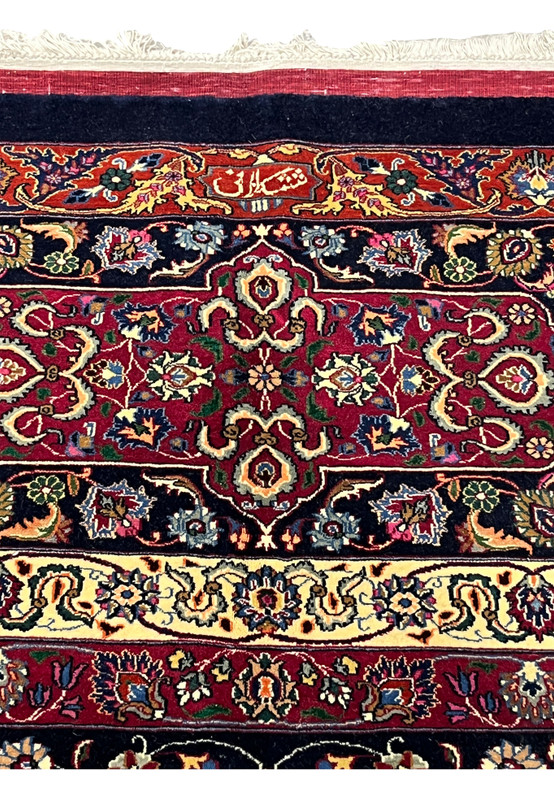 Upper edge of Persian Mashad rug displaying clean finishing, crisp borders, silk highlights, and traditional craftsmanship from the Sheshkalani workshop
