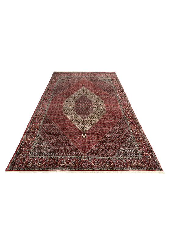 Laid-down view of a Persian Bijar iron rug highlighting its heavy wool pile, precise geometry, strong structure, and balanced layered border design