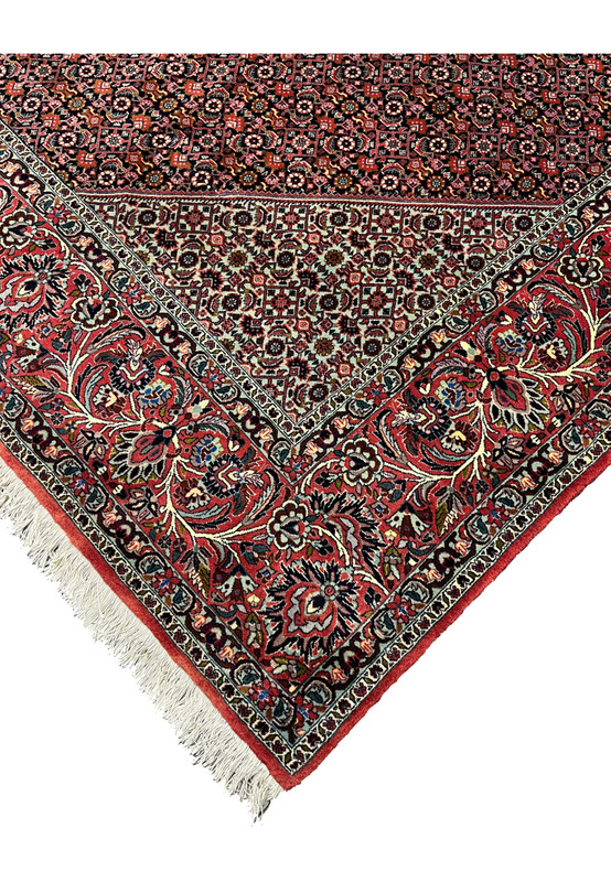 Outer edge detail of a Persian Bijar iron rug featuring strong binding, crisp borders, red wool edge finish, and long-lasting hand-knotted construction