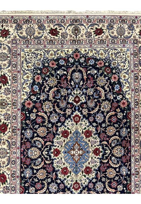 Upper section of Persian Isfahan rug highlighting floral border transition, ivory framing, and precise alignment of vine motifs