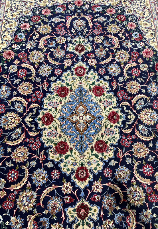 Full medallion view of a Persian Isfahan wool and silk rug with layered floral geometry, silk outlining, and crisp high knot density definition