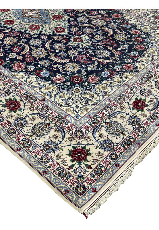 Side edge view of a Persian Isfahan rug showing clean selvedge, tight knot structure, and rich navy, ivory, and burgundy color palette