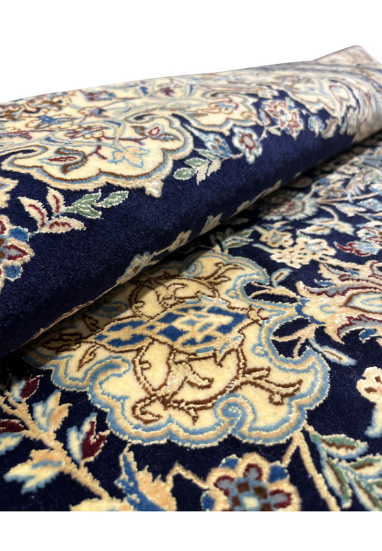 Rolled view of a Persian Nain 6 La rug highlighting pile thickness, silk sheen, and flexible hand-knotted structure