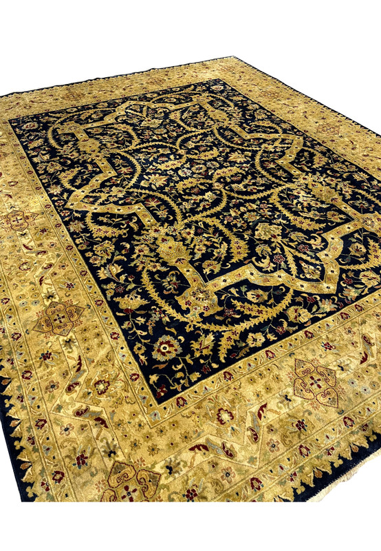 Angled perspective of an 8' x 10' Oriental Agra rug revealing pile texture, navy and gold contrast, distressed surface, and overall decorative presence