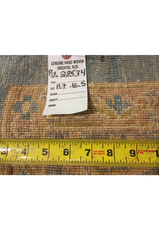 Backside of a hand knotted light blue Chobi Peshawar rug with ruler for scale, showing tight knot structure, wool foundation, and precise craftsmanship