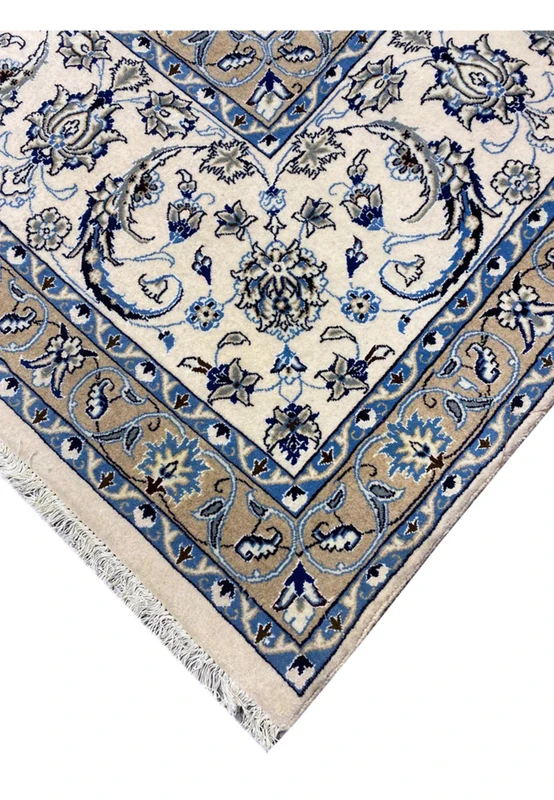 Edge view of a rare 10x19 Persian Nain 9 La rug highlighting crisp borders, ivory and blue floral patterns, and fine wool craftsmanship