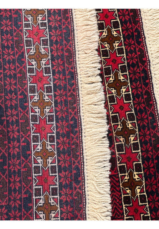 Backside view of a Persian Baluch prayer rug revealing tight knotting, clear pattern visibility, and strong tribal weaving technique