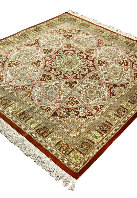 Angled view of signed Amjadi Persian Qum 5 x 5 silk rug displaying sheen variation, star medallion depth, and refined color transitions