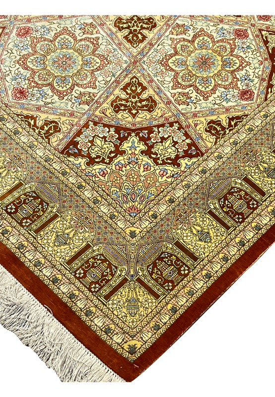 Edge detail of signed Amjadi Persian Qum silk rug showing clean binding, fine knot density, and well-preserved silk fringe