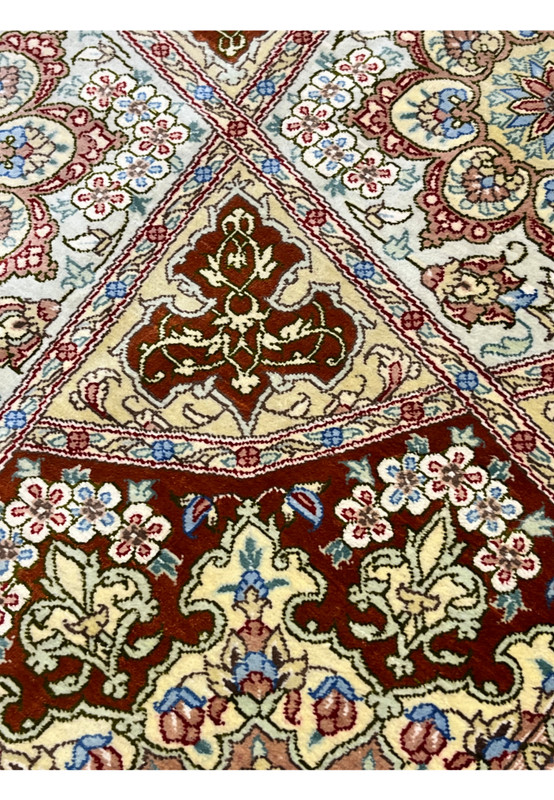 Pattern and motif detail of signed Amjadi Persian Qum silk rug showing floral rosettes, geometric panels, and balanced color harmony