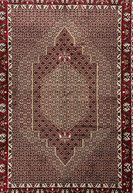 Midfield detail of Persian Senneh rug showing tightly packed geometric lattice, ivory outlines, dark brown accents, and rhythmic repeating motifs