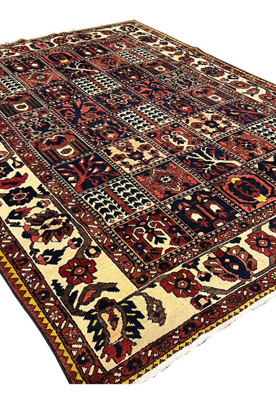 Angled perspective of a Persian Bakhtiar garden rug showing depth, texture, and pictorial panel design