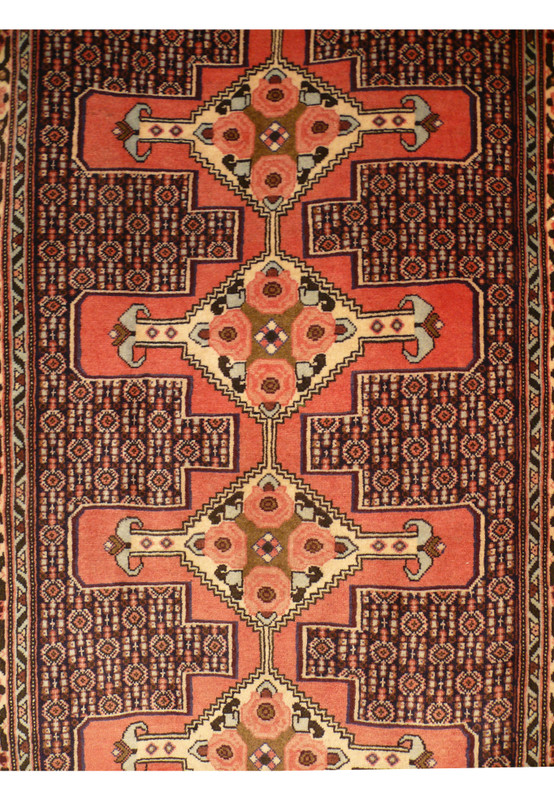 Detailed field section of handmade Persian runner with repeating boteh style forms and dense fine knot weaving