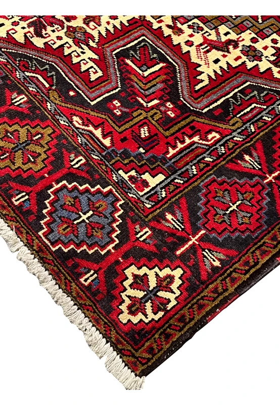 Edge and side binding of hand knotted Heriz rug showing sturdy selvedge wool construction tight knots and durable finish