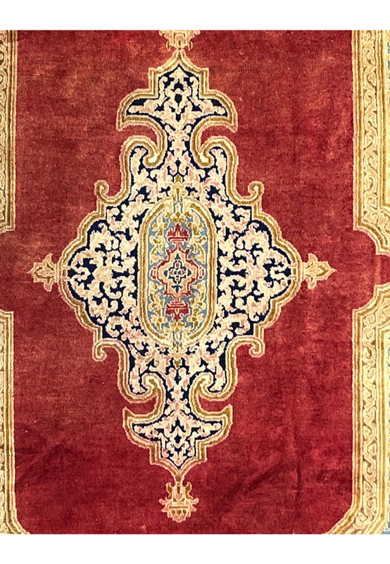 Zoomed medallion closeup antique Kerman rug fine knots ivory navy arabesque floral pattern aged wool surface