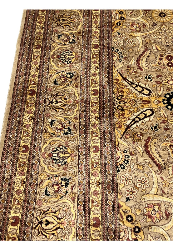 Side view of rug thickness and wool pile texture with visible vintage fading and soft sheen