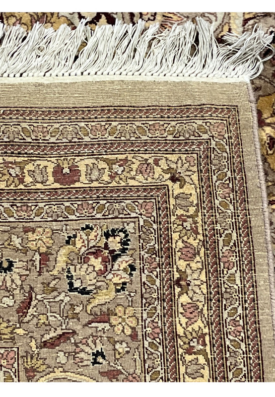 Backside view of hand knotted Agra rug displaying tight knot structure, natural wool foundation, fringe, and authentic handmade craftsmanship