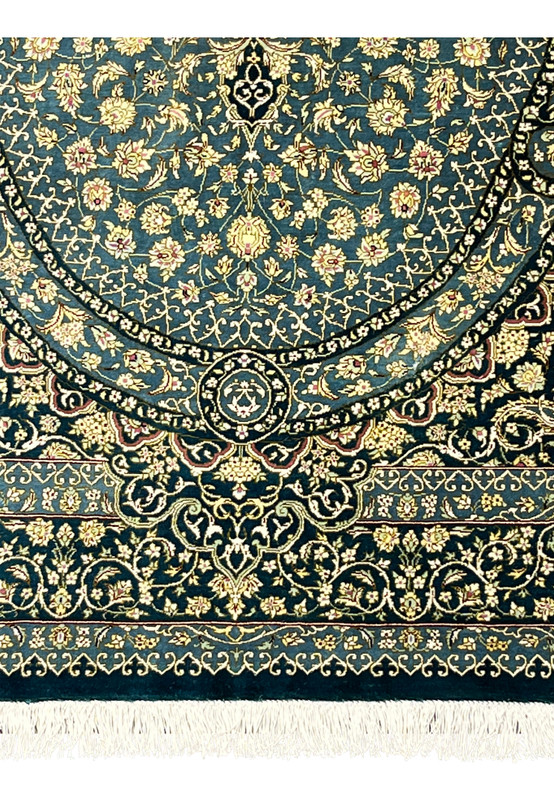 Lower border detail of silk Qum rug with cream florals, teal ground and wine red accents, sharp silk outlines
