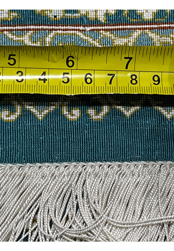 Backside closeup with ruler measuring knot density on pure silk Qum rug highlighting extremely fine 1000 KPSI weave and precision weaving