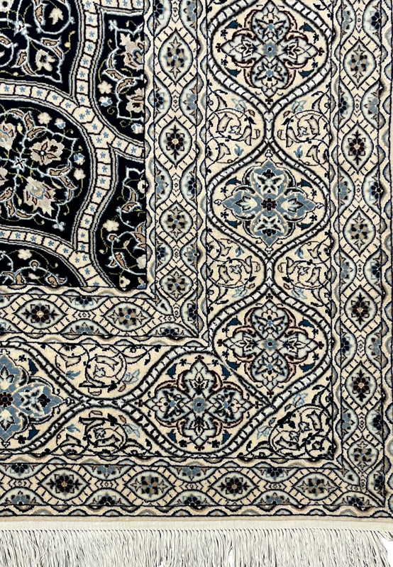 Detailed border of Persian Nain Habibian rug with scrolling vines ivory and light blue floral motifs silk accents.