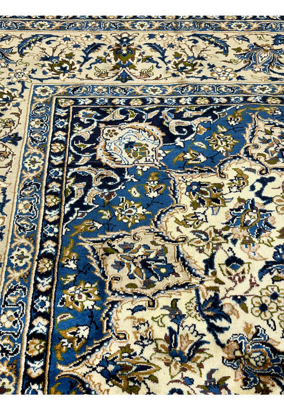 10'2 x 14'3 Persian Kashan rug inner border closeup showing navy floral guard stripes ivory ground intricate vine details and fine wool weave