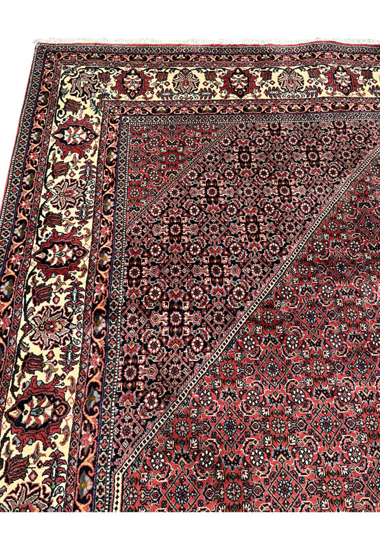 Upper border detail of 8'2 x 11'4 Persian Bijar Iron Rug in deep red and ivory with traditional floral guard borders and strong outlines