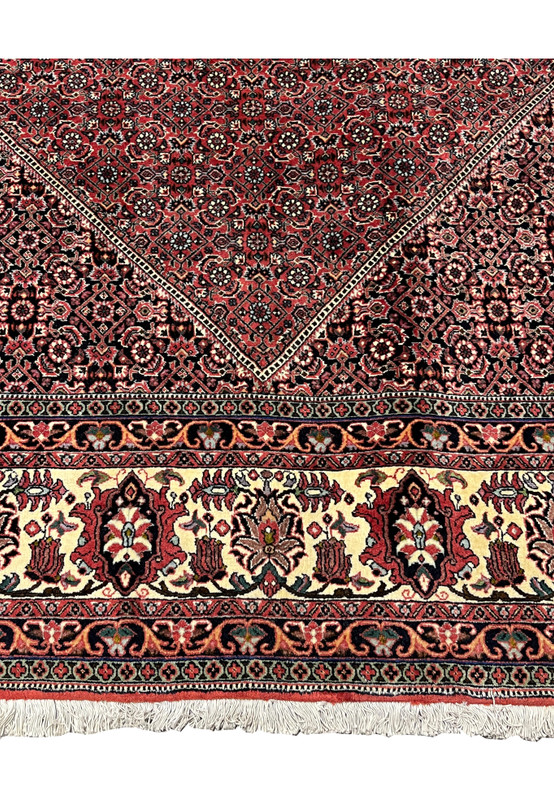 Lower border view of 8'2 x 11'4 Persian Bijar Iron Rug featuring ivory floral panels, red accents and traditional repeating Persian motifs