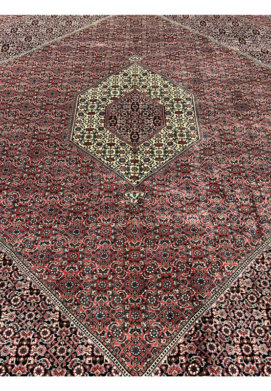 Midfield close up of Persian Bijar Iron Rug 8'2 x 11'4 with dense Herati pattern, brick red ground and intricate geometric detailing