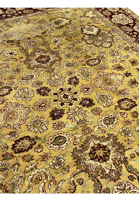 Field detail of antique style gold Indian Agra rug showing intricate floral pattern and vine scrolls.
