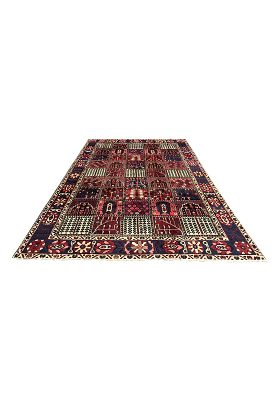 7x10 Persian Bakhtiari panel rug laid flat on floor, red navy ivory colors
