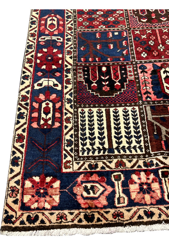 Navy main border with rosette and vine motifs on 7x10 Persian Bakhtiari panel rug