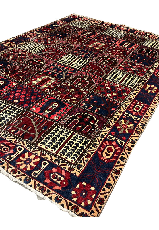 Angled view of 7x10 Persian Bakhtiari panel rug showing wool pile depth and texture