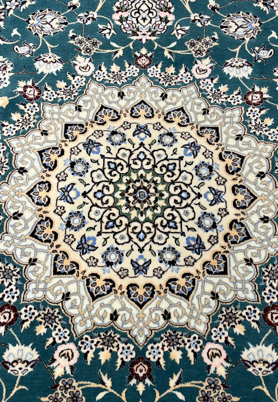 Close-up of ivory star medallion on 7x10 Persian Nain 6La Habibian teal and ivory rug