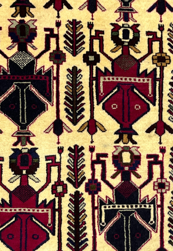Zoomed detail of boteh and vase forms in 5x8 Persian Afshar ivory navy and burgundy tribal rug