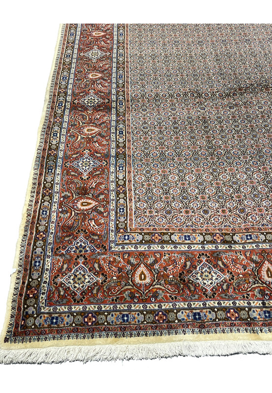 Red main border with paisley boteh and diamond rosettes on Persian Moud wool rug