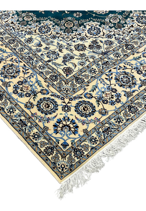 Full-length side profile of this authentic 8x12 Nain rug with ivory fringe and layered floral borders