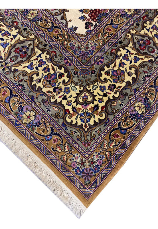 Edge detail of this Persian Qum rug showing gold mustard border floral cartouches and ivory selvedge